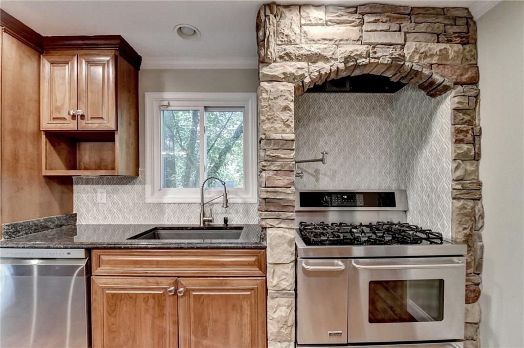 975 Timber Lake Trail Cumming, GA 30041 - Photo 29 of 82 a kitchen with a stove and white cabinets