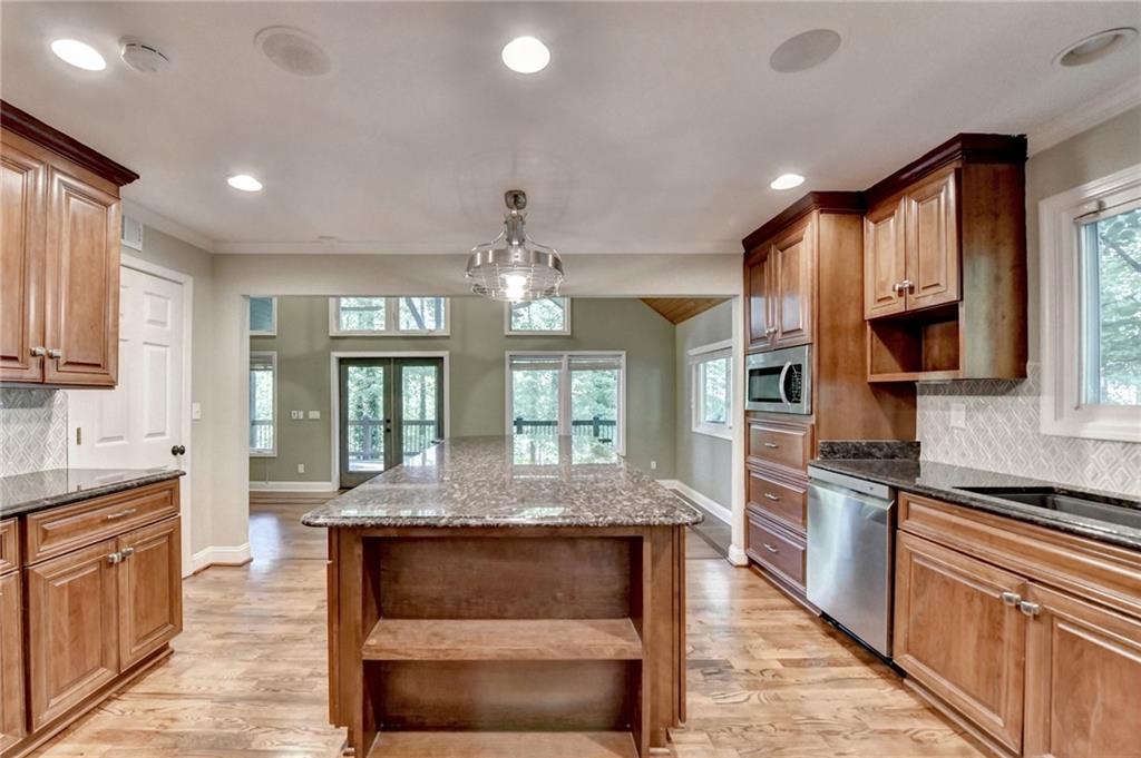 975 Timber Lake Trail Cumming, GA 30041 - Photo 30 of 82 a large kitchen with granite countertop a large counter top appliances and cabinets