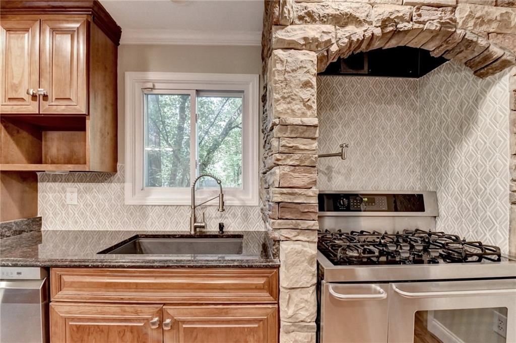 975 Timber Lake Trail Cumming, GA 30041 - Photo 32 of 82 a kitchen with a stove and a white cabinet