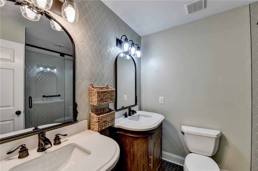 975 Timber Lake Trail Cumming, GA 30041 - Photo 47 of 82 a bathroom with a toilet sink and mirror