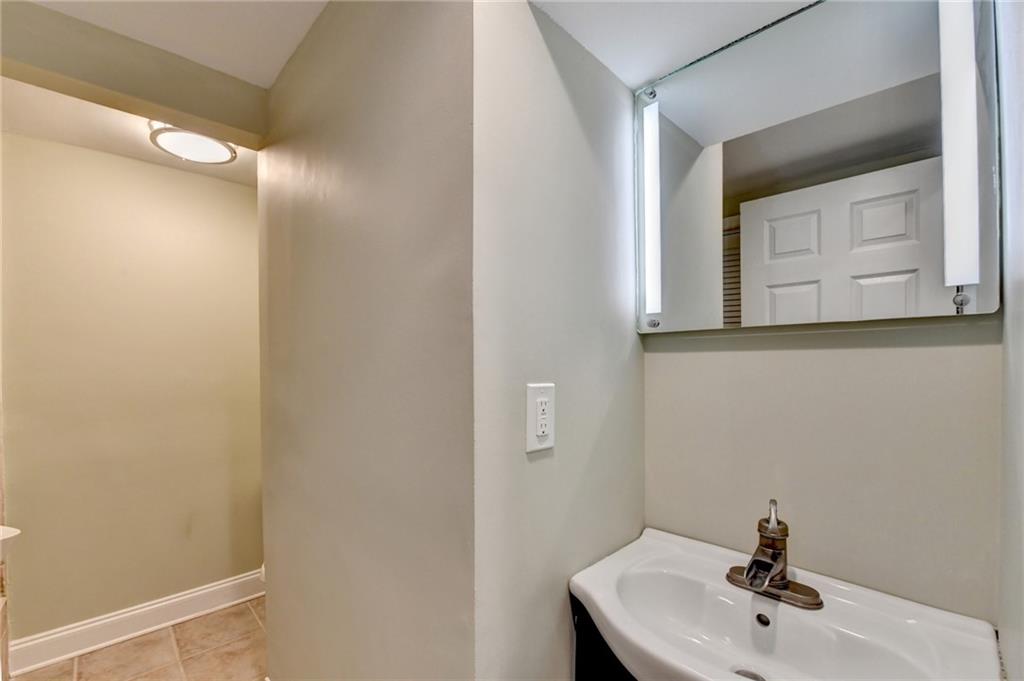 975 Timber Lake Trail Cumming, GA 30041 - Photo 62 of 82 a bathroom with a sink and mirror