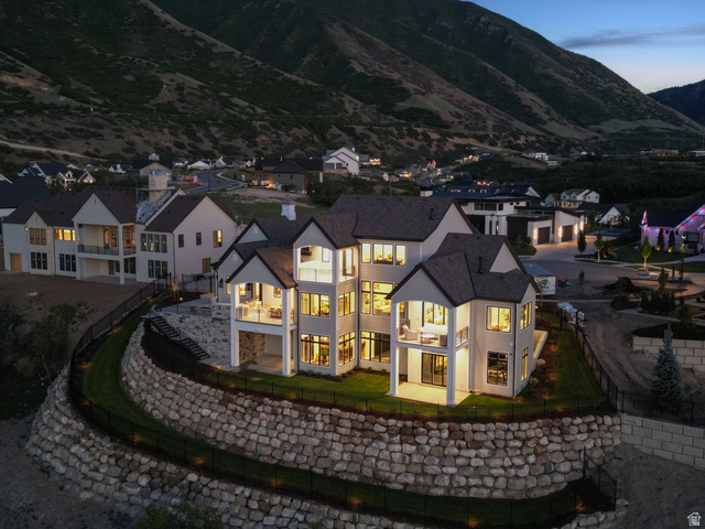 115 East Hidden Ridge Lane, Unit 42 Mapleton, UT 84664 - Photo 91 of 103 Custom-built residence featuring multiple balconies, extensive window placements, and a stone retaining wall