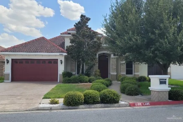 a front view of a house with a garden and garage