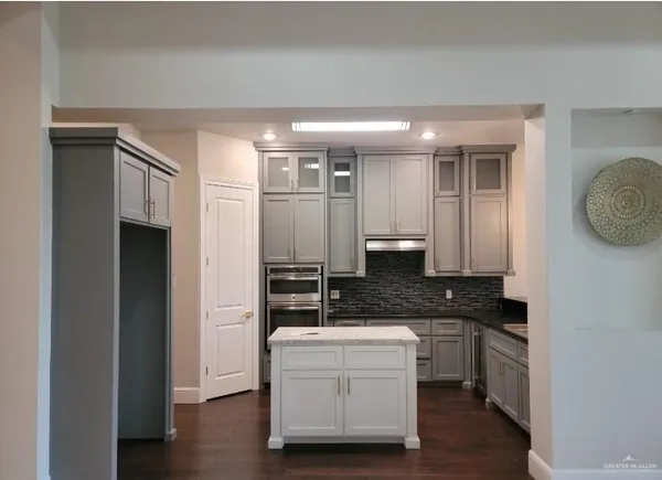 a large kitchen with a large window and stainless steel appliances
