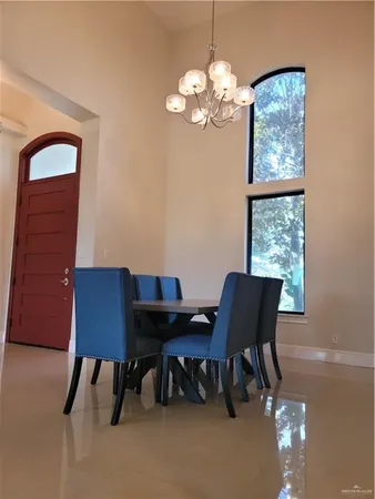 a view of a room with a window and chandelier