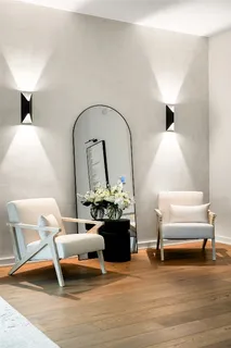 a living room with furniture and a lamp