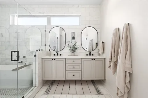 a bathroom with a double vanity sink and a mirror