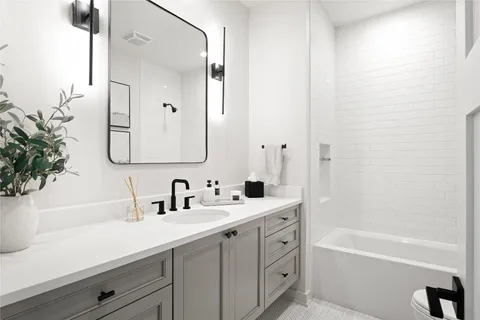 a bathroom with a bathtub a sink and a mirror