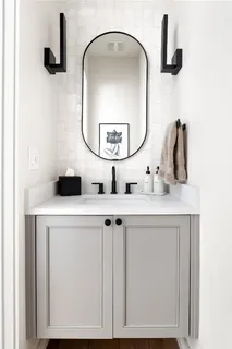 a bathroom with a sink vanity and a mirror