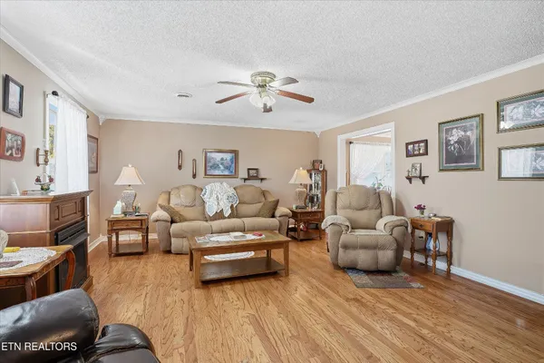 a living room with furniture and a wooden floor