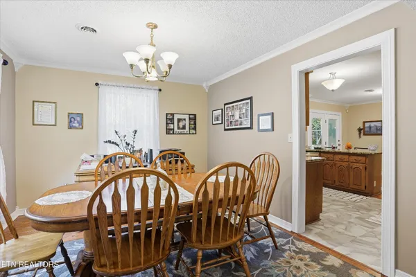a dining room with furniture and chandelier