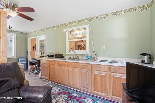 a kitchen with sink cabinets and dining table