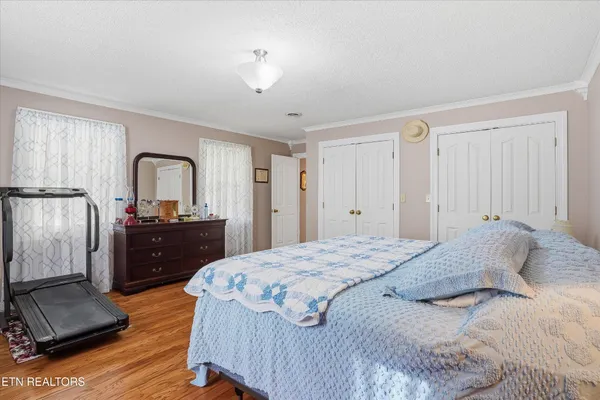 a bedroom with a bed and a dresser