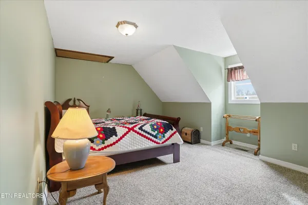 a bedroom with a bed and a workspace