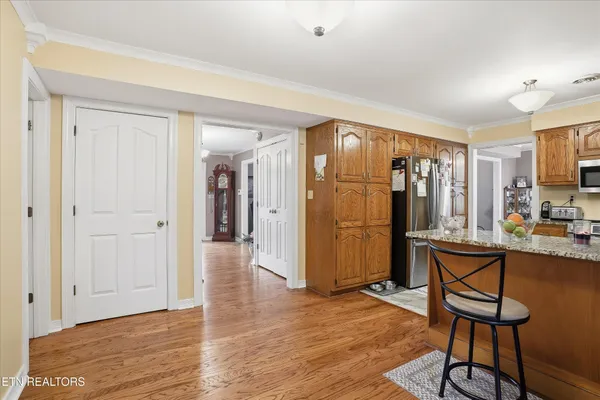a view of a livingroom with furniture hardwood floor and a ceiling fan