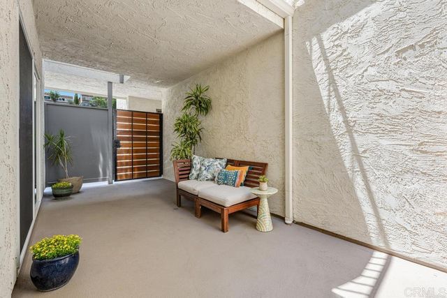a building outdoor space with patio furniture and potted plants