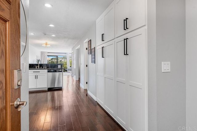 a view of kitchen with refrigerator and wooden floor