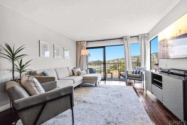 a living room with furniture and large windows