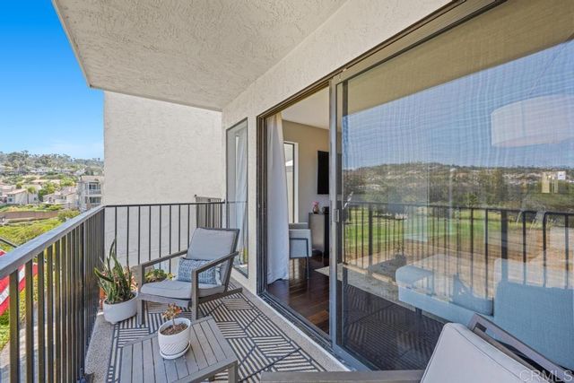 a view of balcony with furniture