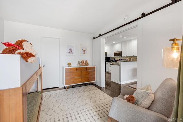 a living room with furniture and kitchen view
