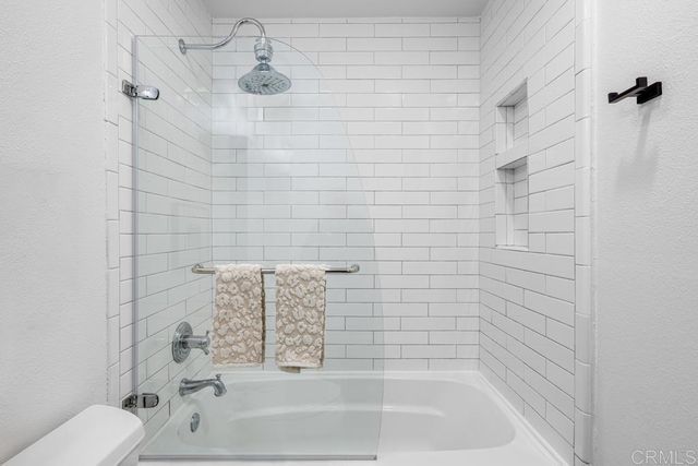 a bathroom with a bathtub and shower