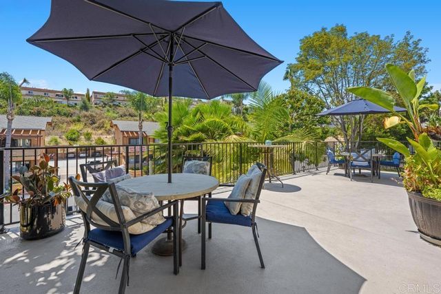 a view of a chairs and table under an umbrella