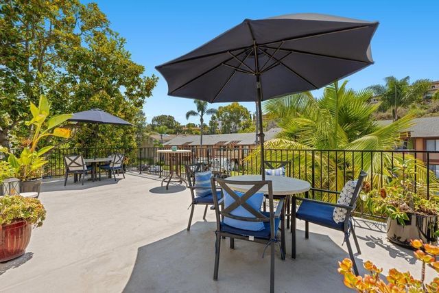 a patio with a patio table and chairs