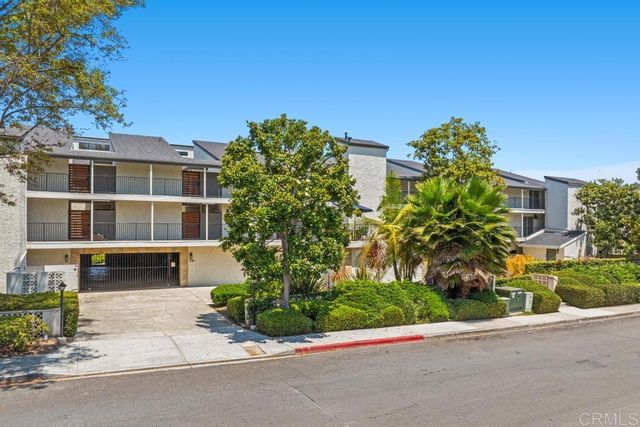 an aerial view of residential houses with outdoor space and river