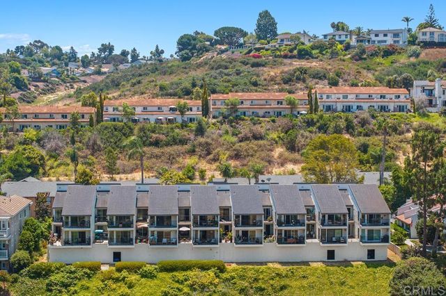 an aerial view of a residential houses with outdoor space