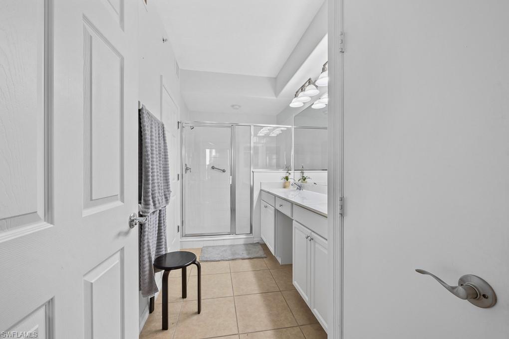 2615 Somerville Loop, Unit 307 Cape Coral, FL 33991 - Photo 12 of 29 a bathroom with a sink a toilet and shower