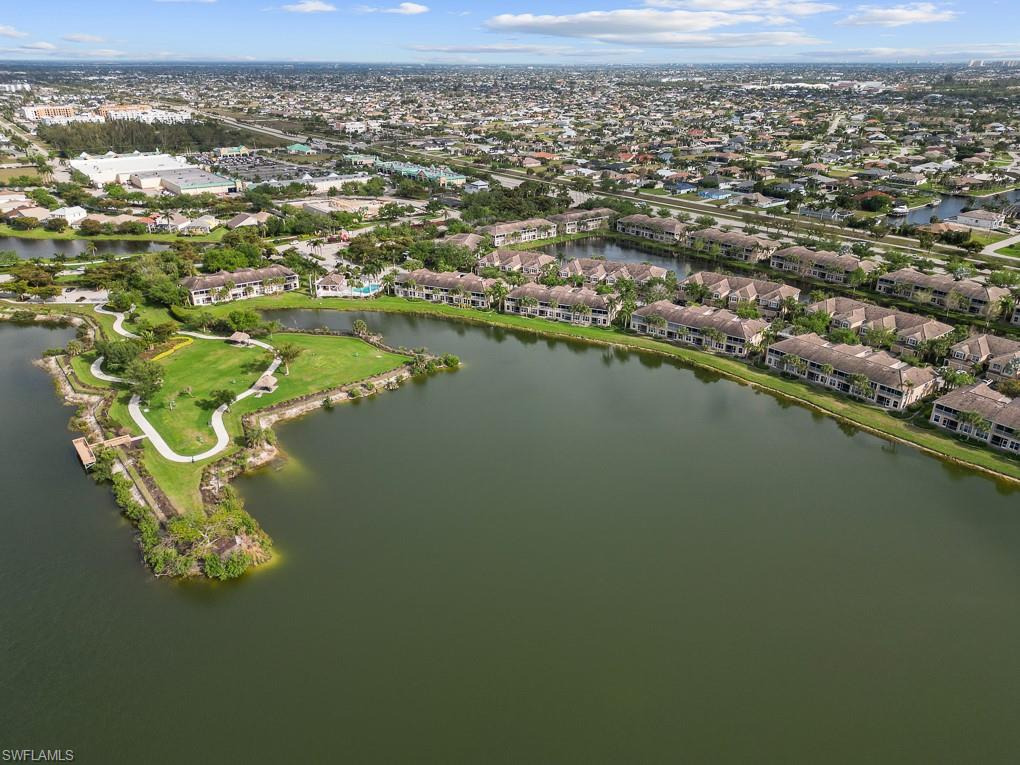 2615 Somerville Loop, Unit 307 Cape Coral, FL 33991 - Photo 23 of 29 an aerial view of a houses with a lake