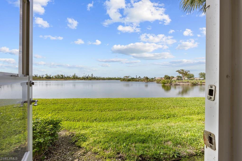 2615 Somerville Loop, Unit 307 Cape Coral, FL 33991 - Photo 9 of 29 a view of a lake with a big yard