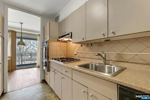 a kitchen that has a sink and cabinets