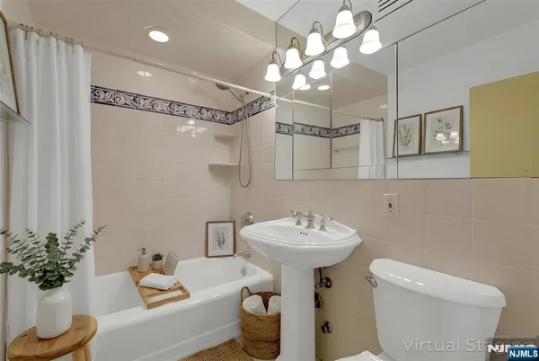a bathroom with a sink mirror and toilet