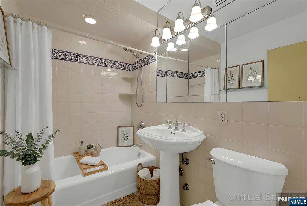 2 Horizon Road, Unit G5 Fort Lee, NJ 07024 - Photo 27 of 46 a bathroom with a sink mirror and toilet