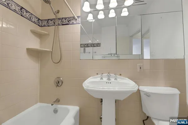 a bathroom with a sink a toilet and bathtub