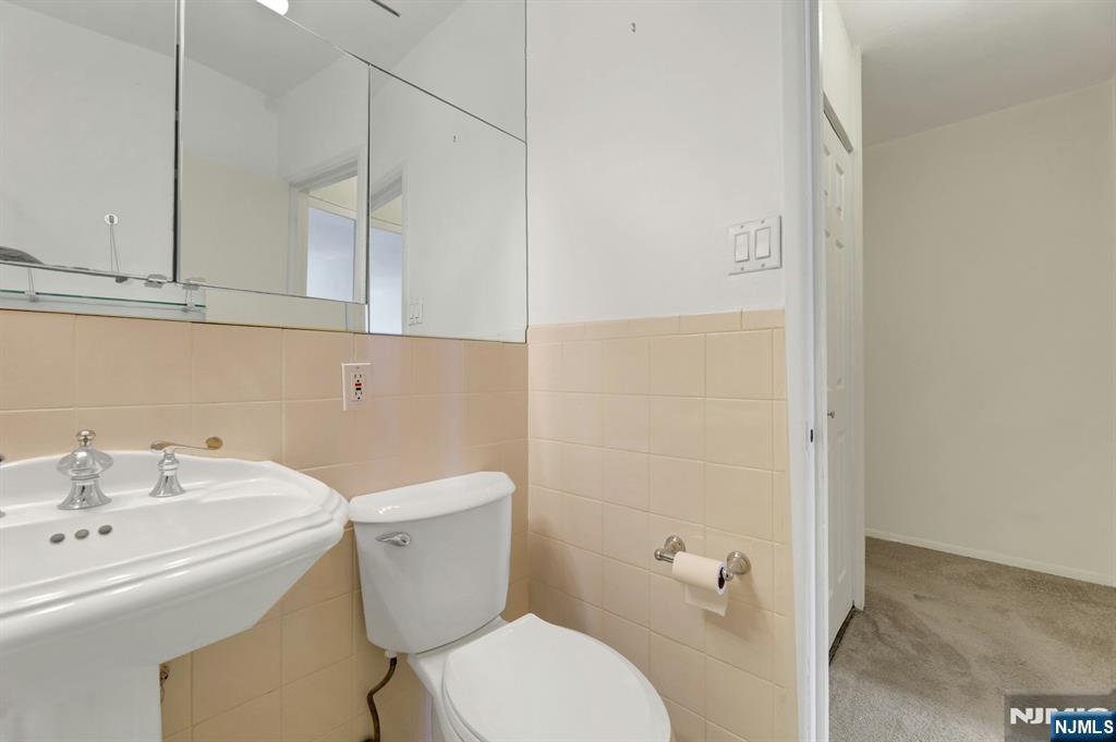 2 Horizon Road, Unit G5 Fort Lee, NJ 07024 - Photo 30 of 46 a bathroom with a sink a toilet and shower