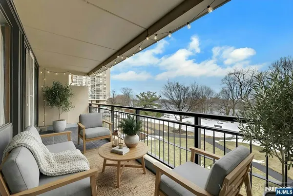 a balcony with furniture and a potted plant
