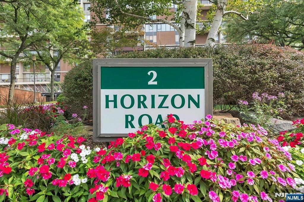 2 Horizon Road, Unit G5 Fort Lee, NJ 07024 - Photo 39 of 46 a sign that is in front of flowers
