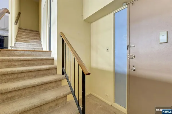 a view of staircase with wooden floor and a bathroom