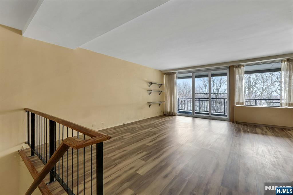 2 Horizon Road, Unit G5 Fort Lee, NJ 07024 - Photo 10 of 46 a view of an empty room with wooden floor and a window