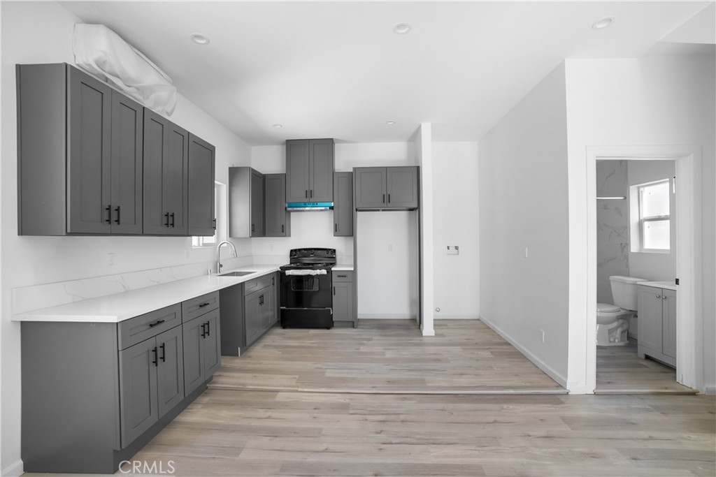a kitchen with stainless steel appliances a sink and cabinets