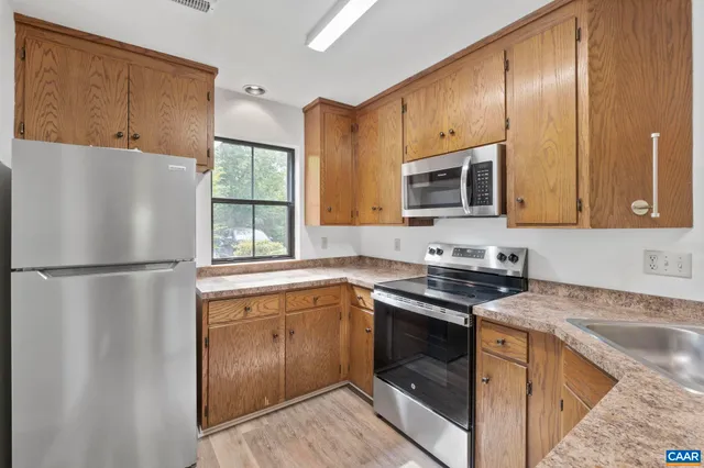 a bathroom with a granite countertop sink a mirror and shower