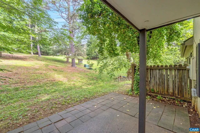 a view of a garden with large trees