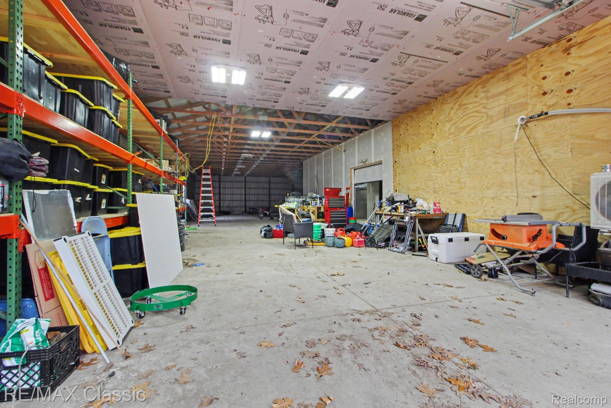 9800 Moon Road Saline, MI 48176 - Photo 27 of 38 Interior of the 100x41 metal pole barn with 2 seperate rooms off to the right and overhead door