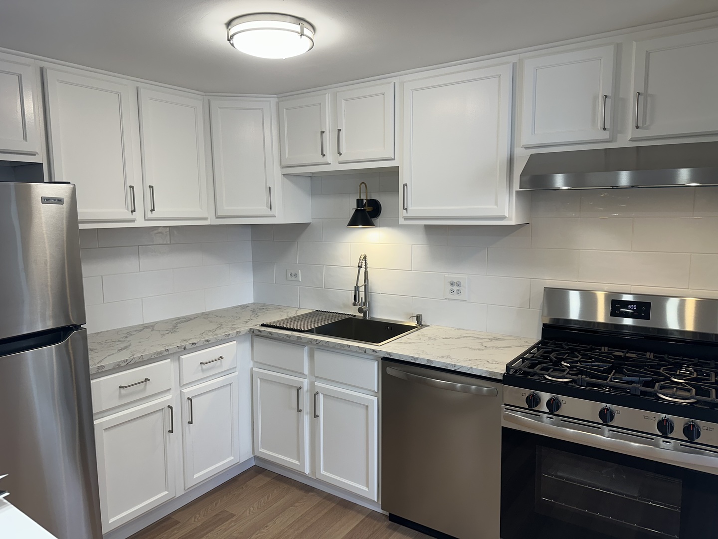 1463 Mercury Drive, Unit 304 Schaumburg, IL 60193 - Photo 2 of 13 a kitchen with white cabinets and appliances