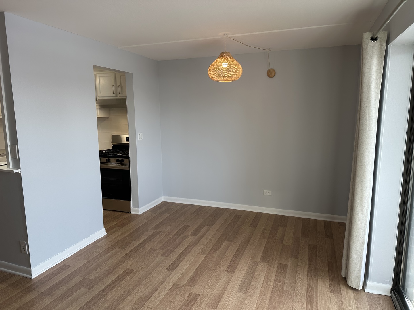 1463 Mercury Drive, Unit 304 Schaumburg, IL 60193 - Photo 6 of 13 an empty room with wooden floor and windows