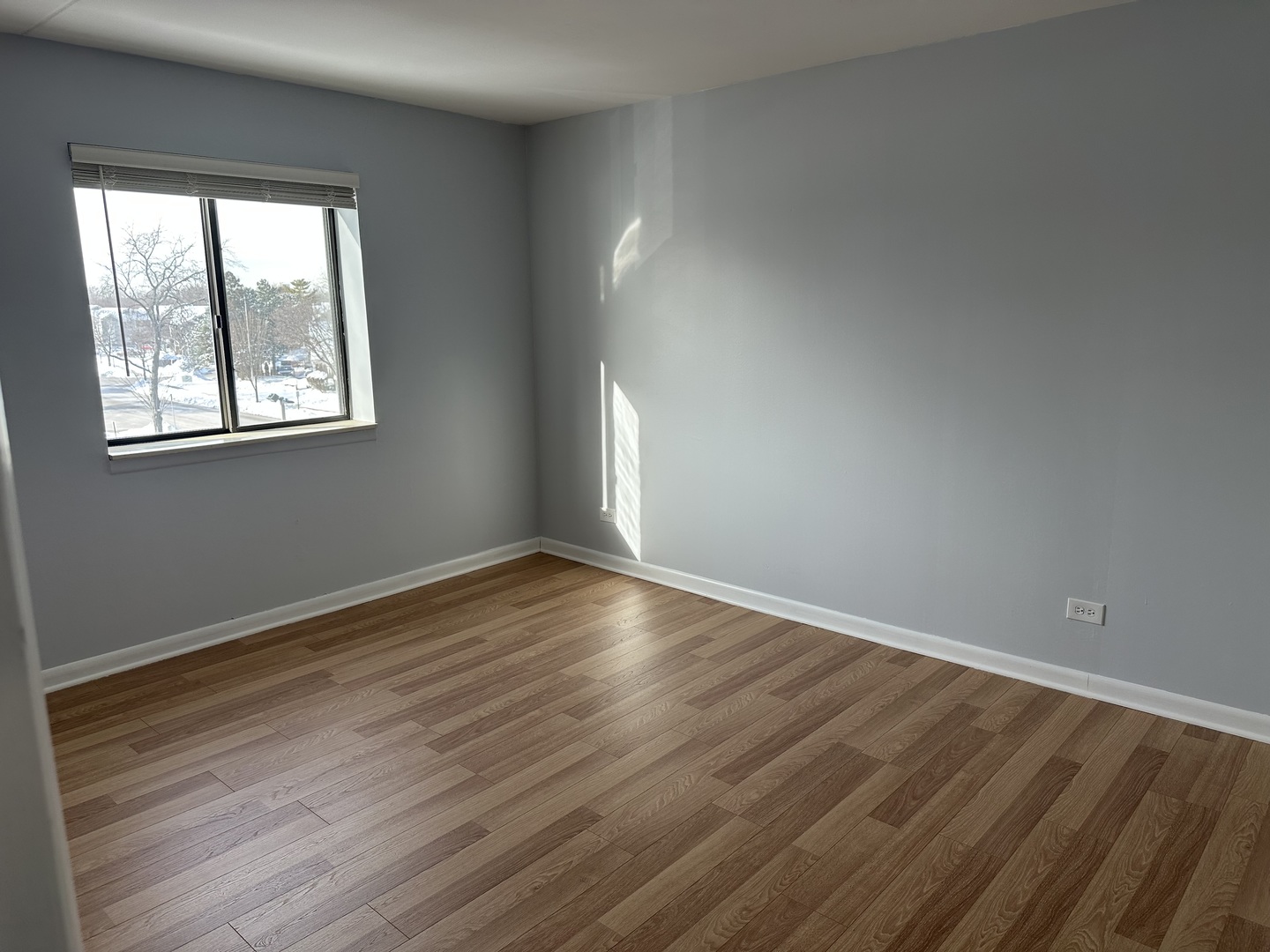 1463 Mercury Drive, Unit 304 Schaumburg, IL 60193 - Photo 8 of 13 an empty room with wooden floor and windows