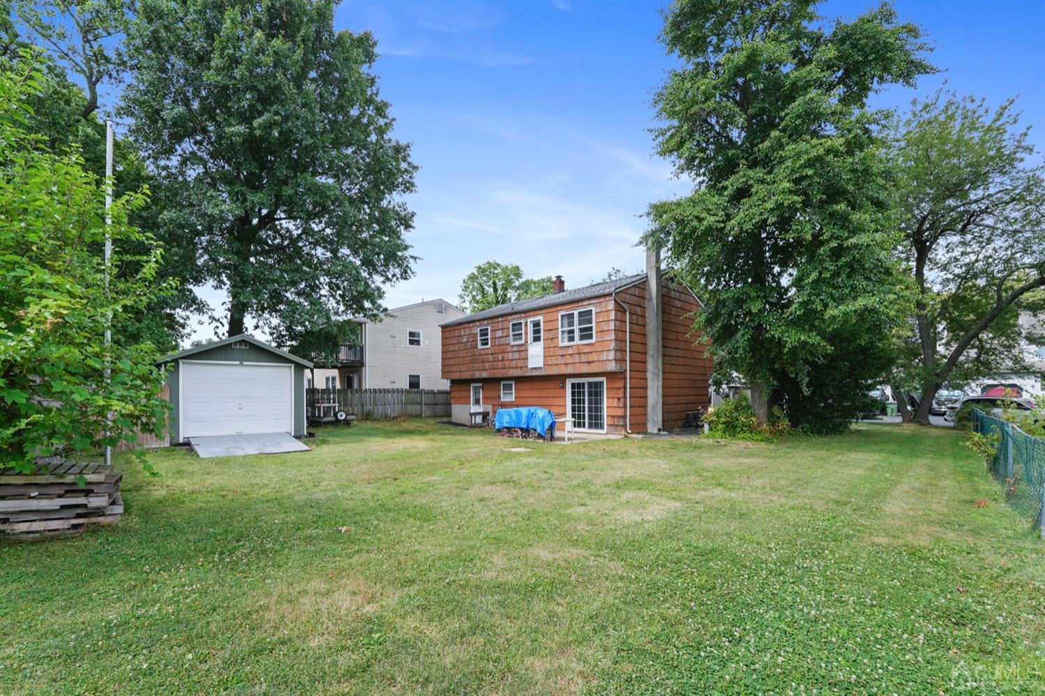 19 Spencer Street Edison, NJ 08817 - Photo 20 of 23 a view of a house with a yard and sitting area