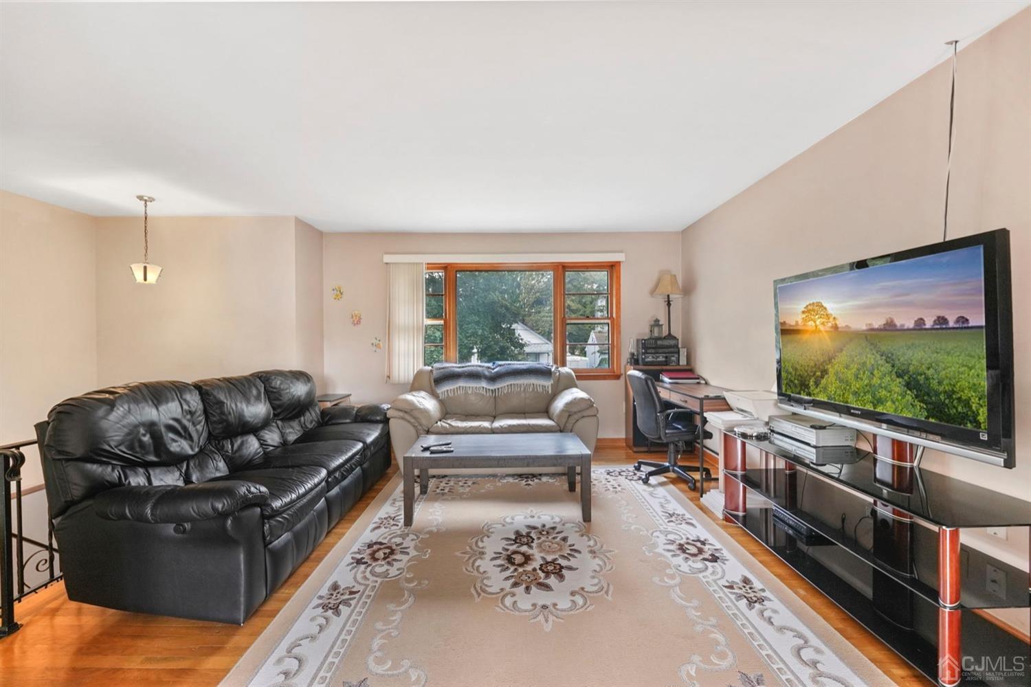 19 Spencer Street Edison, NJ 08817 - Photo 4 of 23 a living room with furniture and a flat screen tv